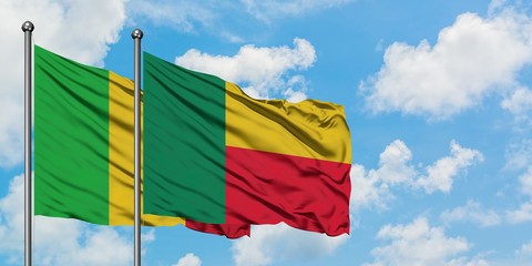 Mali and Benin flag waving in the wind against white cloudy blue sky together. Diplomacy concept, international relations.