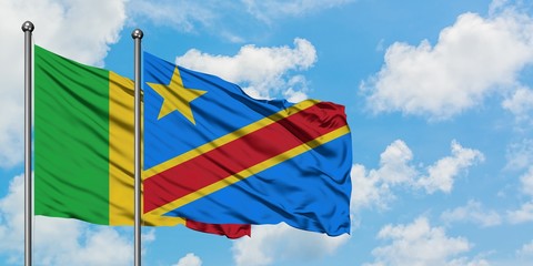 Mali and Congo flag waving in the wind against white cloudy blue sky together. Diplomacy concept, international relations.