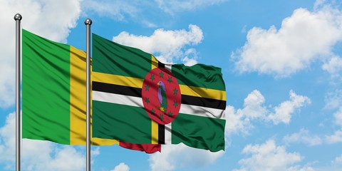 Mali and Dominica flag waving in the wind against white cloudy blue sky together. Diplomacy concept, international relations.