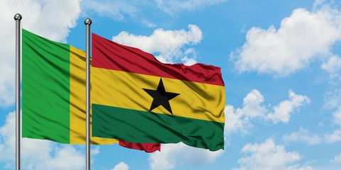 Mali and Ghana flag waving in the wind against white cloudy blue sky together. Diplomacy concept, international relations.