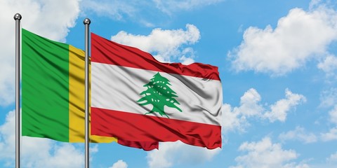 Mali and Lebanon flag waving in the wind against white cloudy blue sky together. Diplomacy concept, international relations.
