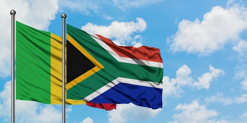 Mali and South Africa flag waving in the wind against white cloudy blue sky together. Diplomacy concept, international relations.