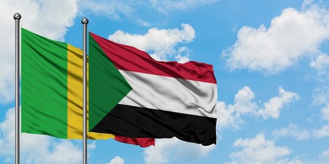 Mali and Sudan flag waving in the wind against white cloudy blue sky together. Diplomacy concept, international relations.