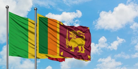 Mali and Sri Lanka flag waving in the wind against white cloudy blue sky together. Diplomacy concept, international relations.