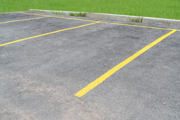 Fototapeta premium yellow lines parking on asphalt background