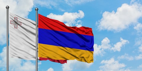 Malta and Armenia flag waving in the wind against white cloudy blue sky together. Diplomacy concept, international relations.
