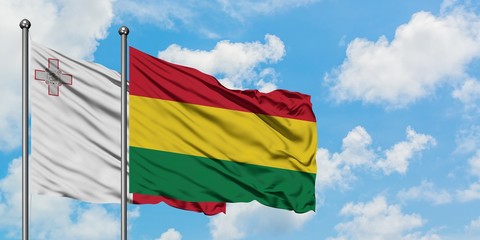 Malta and Bolivia flag waving in the wind against white cloudy blue sky together. Diplomacy concept, international relations.
