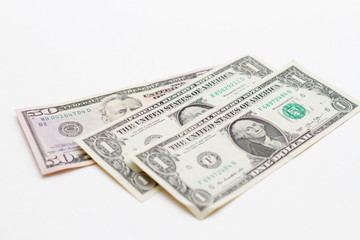Stack of dollar bills on white background. USA dollar bills are scattered
