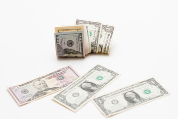 Dollar bills of different denominations on a white background. Paper money american dollars