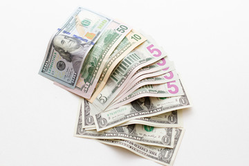Scattered money USA dollars. Dollar bills of different denominations on a white background