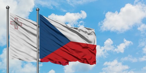 Malta and Czech Republic flag waving in the wind against white cloudy blue sky together. Diplomacy concept, international relations.