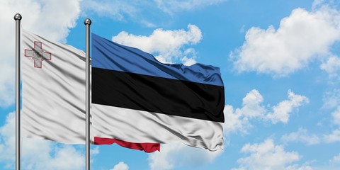 Malta and Estonia flag waving in the wind against white cloudy blue sky together. Diplomacy concept, international relations.