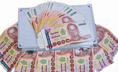 Thai banknotes on gray background.A banknote (often known as a bill (in the USA), paper money, or simply a note) is a type of negotiable promissory note, made a bank, payable to the bearer on demand.