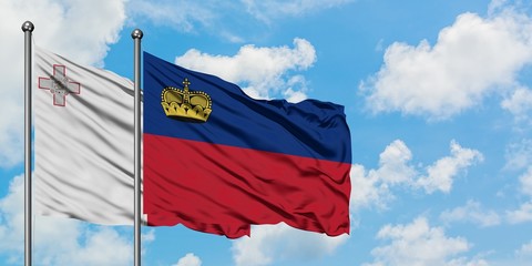 Malta and Liechtenstein flag waving in the wind against white cloudy blue sky together. Diplomacy concept, international relations.