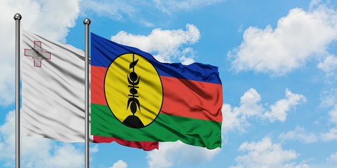 Malta and New Caledonia flag waving in the wind against white cloudy blue sky together. Diplomacy concept, international relations.