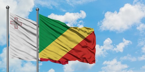 Malta and Republic Of The Congo flag waving in the wind against white cloudy blue sky together. Diplomacy concept, international relations.