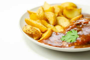 Cooked chicken breast fillet in a barbecue sauce, topped with smoked bacon and Red Leicester cheese and served with potato wedges