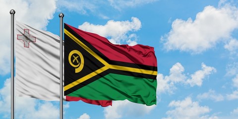 Malta and Vanuatu flag waving in the wind against white cloudy blue sky together. Diplomacy concept, international relations.