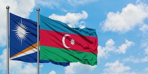 Marshall Islands and Azerbaijan flag waving in the wind against white cloudy blue sky together. Diplomacy concept, international relations.