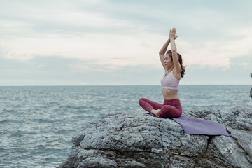 Side view of woman doing exercise yoga. sitting in Sukhasana exercise, Easy Seat pose pose. Amazing...