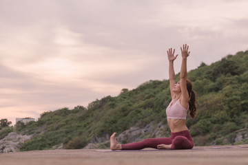 Young women practicing yoga and practicing yoga postures Amazing yoga landscape in the beautiful...