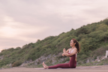 Young women practicing yoga and practicing yoga postures Amazing yoga landscape in the beautiful...