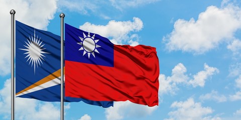 Marshall Islands and Taiwan flag waving in the wind against white cloudy blue sky together. Diplomacy concept, international relations.