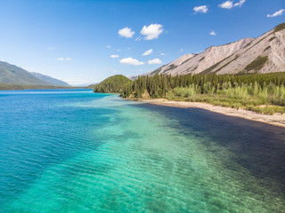 Beautiful turquoise colored water in Muncho Lake, Canada