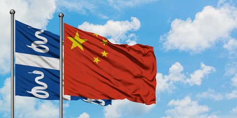 Martinique and China flag waving in the wind against white cloudy blue sky together. Diplomacy concept, international relations.