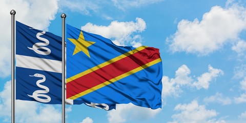 Martinique and Congo flag waving in the wind against white cloudy blue sky together. Diplomacy concept, international relations.