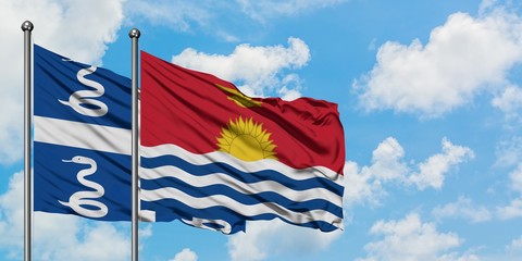 Martinique and Kiribati flag waving in the wind against white cloudy blue sky together. Diplomacy concept, international relations.