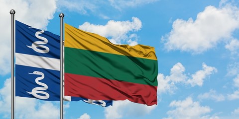 Martinique and Lithuania flag waving in the wind against white cloudy blue sky together. Diplomacy concept, international relations.