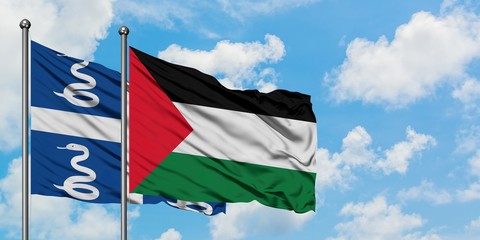 Martinique and Palestine flag waving in the wind against white cloudy blue sky together. Diplomacy concept, international relations.