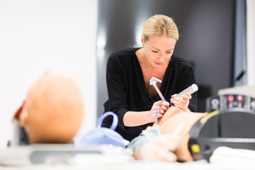 Medical doctor specialist expert displaying method of patient intubation technique on hands on...