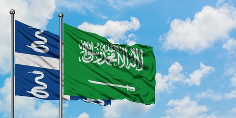Martinique and Saudi Arabia flag waving in the wind against white cloudy blue sky together. Diplomacy concept, international relations.