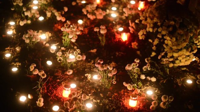 tomb decorated with flowers and candles on the occasion of the &rdquo;Day of the Dead&rdquo;
