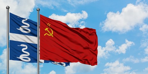 Martinique and Soviet Union flag waving in the wind against white cloudy blue sky together. Diplomacy concept, international relations.