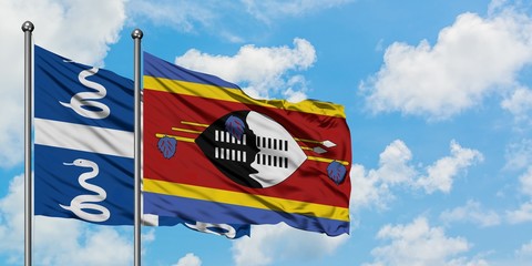 Martinique and Swaziland flag waving in the wind against white cloudy blue sky together. Diplomacy concept, international relations.