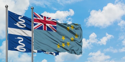 Martinique and Tuvalu flag waving in the wind against white cloudy blue sky together. Diplomacy...