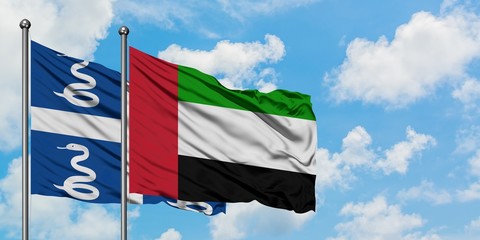 Martinique and United Arab Emirates flag waving in the wind against white cloudy blue sky together. Diplomacy concept, international relations.