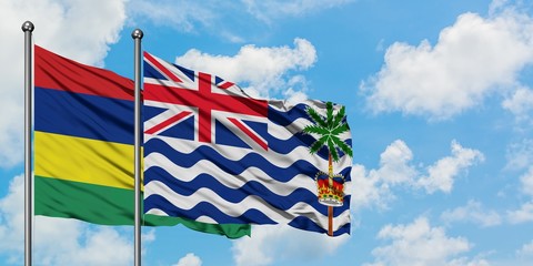 Mauritius and British Indian Ocean Territory flag waving in the wind against white cloudy blue sky together. Diplomacy concept, international relations.