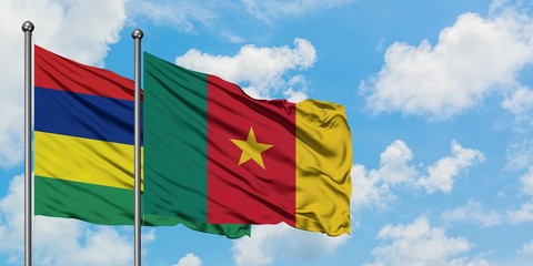 Mauritius and Cameroon flag waving in the wind against white cloudy blue sky together. Diplomacy concept, international relations.