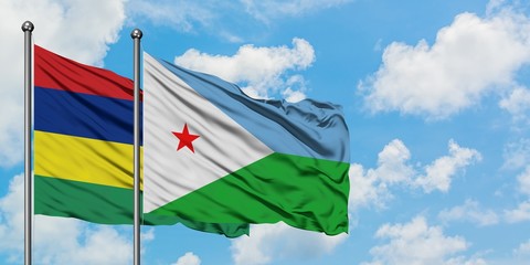 Mauritius and Djibouti flag waving in the wind against white cloudy blue sky together. Diplomacy concept, international relations.