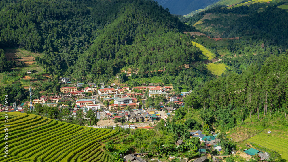 Wall mural beautiful dramatic view of mountains surround mu cang chai city with growing golden paddy rice field