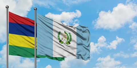 Mauritius and Guatemala flag waving in the wind against white cloudy blue sky together. Diplomacy concept, international relations.