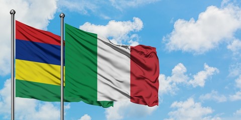 Mauritius and Italy flag waving in the wind against white cloudy blue sky together. Diplomacy concept, international relations.