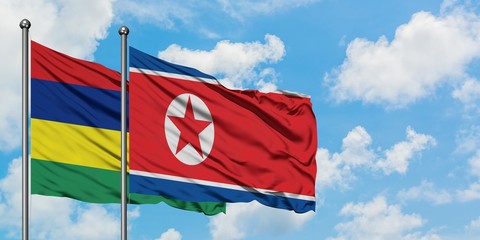 Mauritius and North Korea flag waving in the wind against white cloudy blue sky together. Diplomacy concept, international relations.