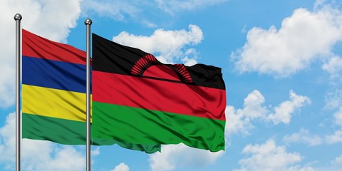 Mauritius and Malawi flag waving in the wind against white cloudy blue sky together. Diplomacy concept, international relations.