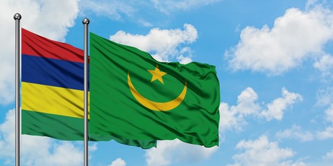 Mauritius and Mauritania flag waving in the wind against white cloudy blue sky together. Diplomacy concept, international relations.
