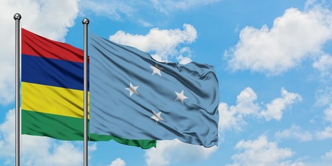 Mauritius and Micronesia flag waving in the wind against white cloudy blue sky together. Diplomacy concept, international relations.